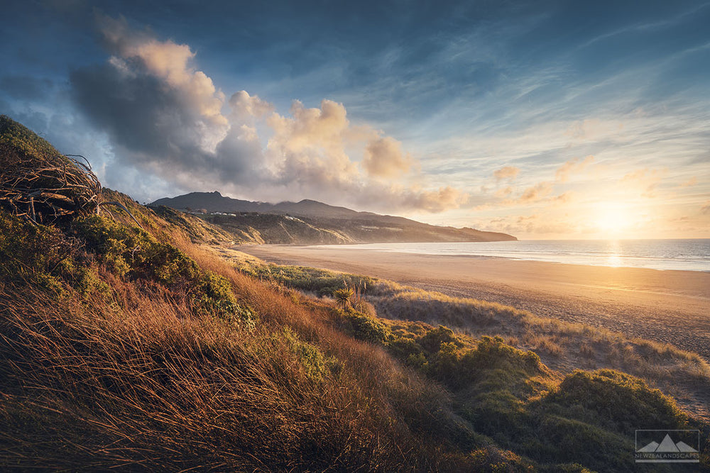 Sunset over the black sand beach of Ngarunui in Raglan, Waikato